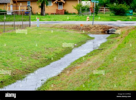 Rainwater in a ditch flows into a drain in Oklahoma, USA Stock Photo ...