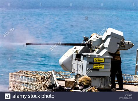 Gun crew fire a 30 mm cannon on the RFA Cardigan Bay, Royal Fleet ...