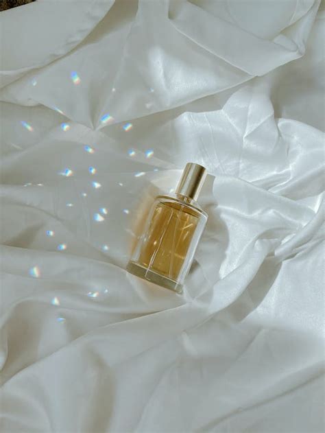 Vial of Perfume on White Fabric · Free Stock Photo