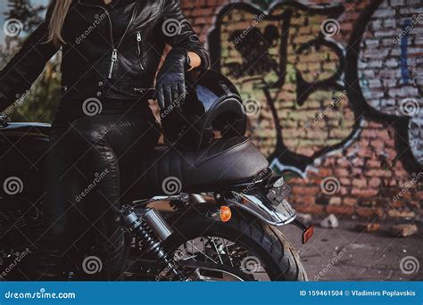 Female Biker in Black with Her Motorbike Next To Graffity Wall Stock ...