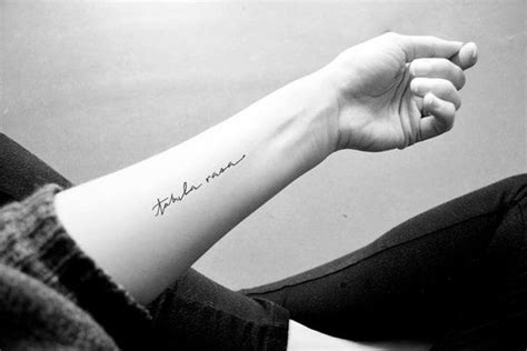 a woman's arm with a small tattoo on it that says, i love you