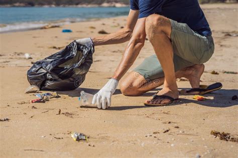 Man in Gloves Pick Up Plastic Bags that Pollute Sea. Problem of Spilled ...