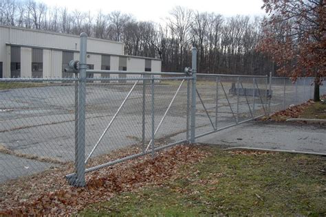 galvanized chain link fence with 16' cantilever gate opening and nylon ...