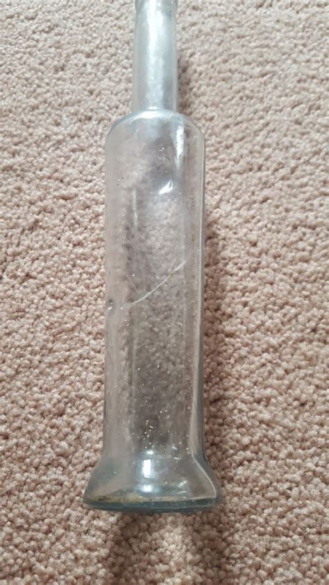 Tall thin clear bottle found on beach with oddity inside — Historic ...