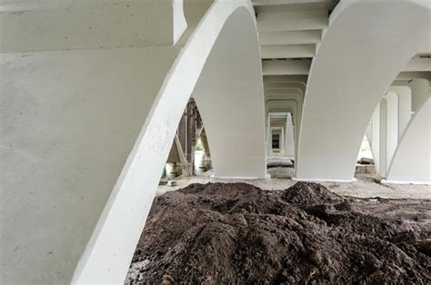 Premium Photo | A large pile of dirt is under a bridge that is under ...