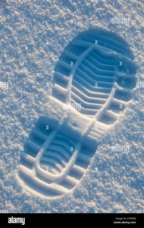 Closeup of a shoe print on snow surface Stock Photo - Alamy