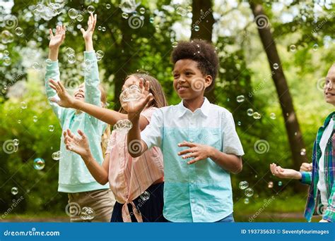 Children Playing with Bubbles in Park Stock Image - Image of enjoyment ...