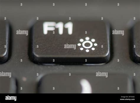 F11 and decrease brightness key on a laptop keyboard Stock Photo - Alamy