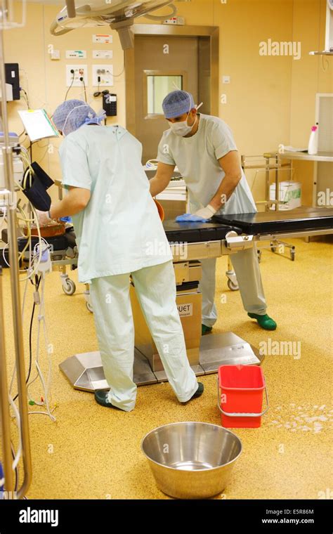 Hospital cleaning staff disinfecting operating room Stock Photo ...