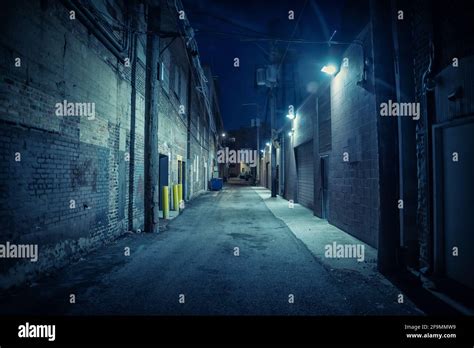 Dark and eerie urban city alley at night Stock Photo - Alamy