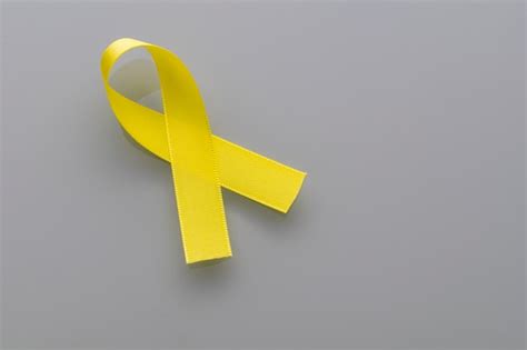 Premium Photo | Yellow ribbon of the suicide prevention campaign ...