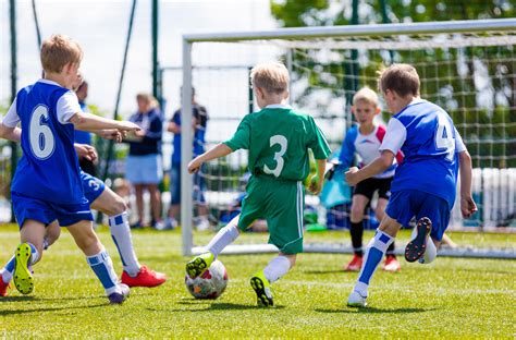 Football soccer match for children. Boys playing football game on a ...