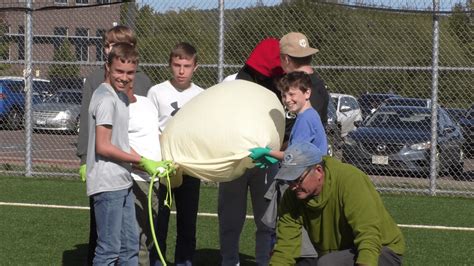 Students learning about science and forecast with a weather balloon ...