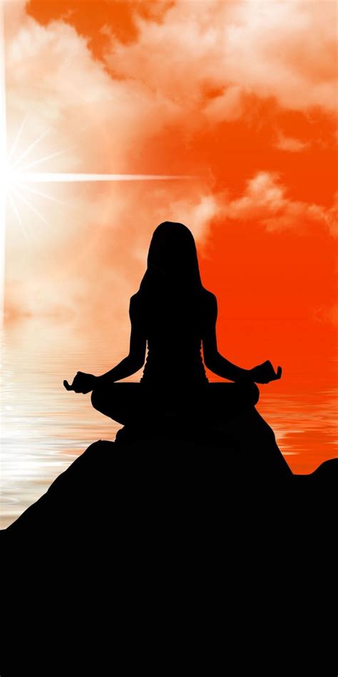 the silhouette of a woman meditating in front of an orange and red sky ...