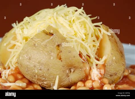 Jacket potato with cheese and beans Stock Photo - Alamy