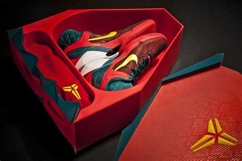 a pair of sneakers in a red shoe box next to an open nike sneaker