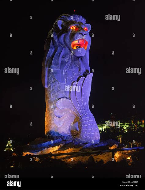 The Merlion statue the symbol of Singapore in blue light at night in ...