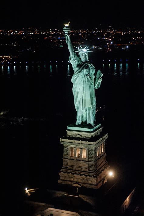 Check out these breathtaking nighttime photos of the Statue of Liberty