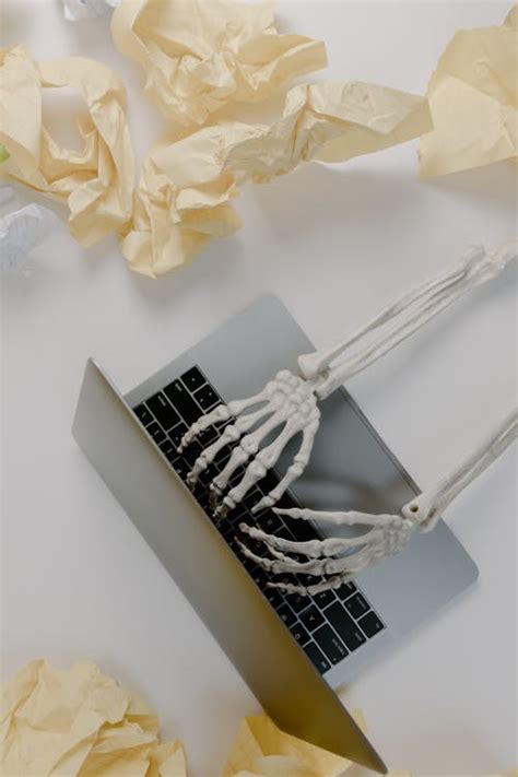 White Skeleton Figurine on Black Laptop Computer · Free Stock Photo