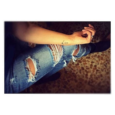 Anchor tattoo on Laura's wrist.