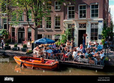 Cafe on a canal bridge, Jordaan district, Amsterdam, Holland Stock ...