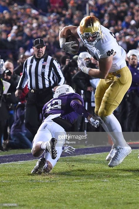 News Photo : Cole Kmet of the Notre Dame Fighting Irish avoids... Notre ...