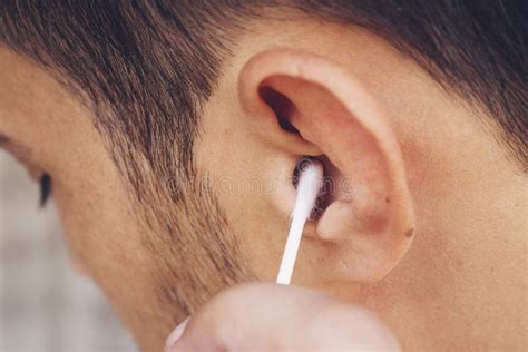 Man about To Clean His Ears Using Q-tip Cotton Swab. Hygiene Essentials ...