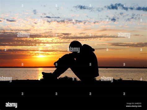 Sad Teenager Silhouette at the Sunset Background Stock Photo - Alamy