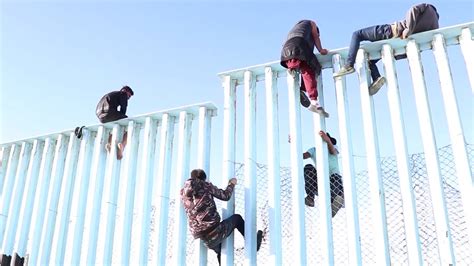 Video shows migrants climbing US-Mexico border fence