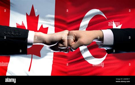 Canada vs Turkey conflict, international relations, fists on flag ...