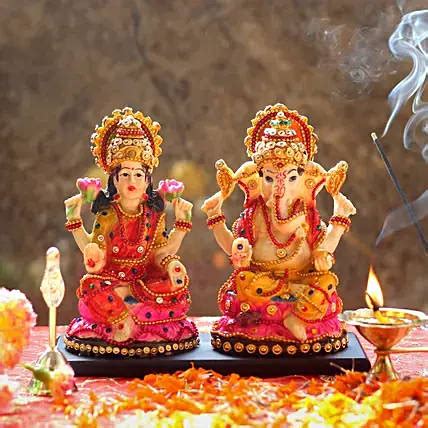 Download Goddess Lakshmi And Lord Ganesh Figures Wallpaper | Wallpapers.com