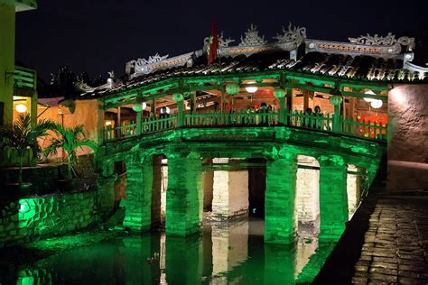 The Japanese Covered Bridge Lit Up In Green Light At Night In Hoi An ...