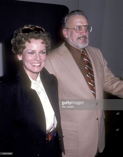 an older man and woman standing next to each other