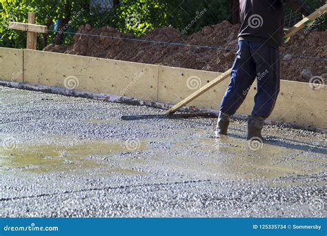 Worker Leveling Fresh Concrete Slab with a Special Working Tool Stock ...