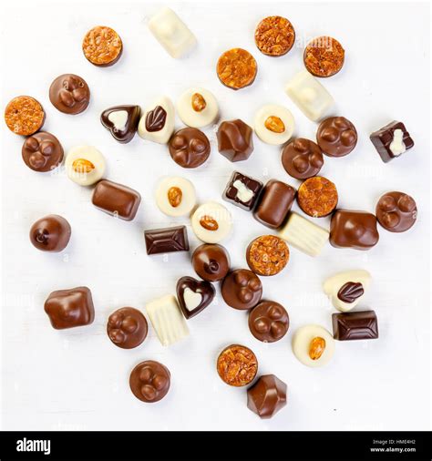 Assortment of delicious chocolate pralines on white table Stock Photo ...