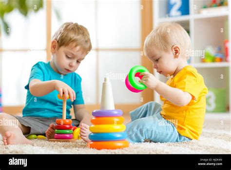 Children playing together. Toddler kid and baby play with blocks ...