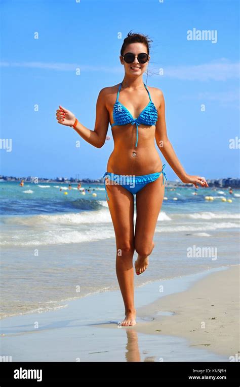 Young woman on the mediterranean beach during hot summer day Stock ...