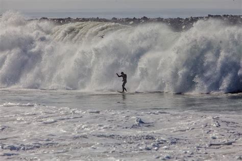 Surfers Tackle 20-Foot Waves While You Sit Inside Reading This