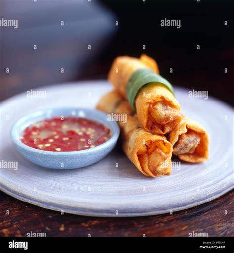 Cha gio (Crispy chicken spring rolls) piled on a round plate with ...