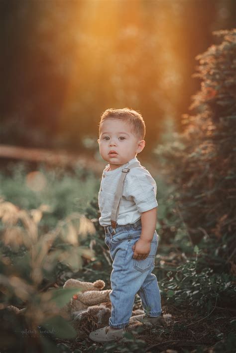 Toddler baby boy in suspenders in a park setting- a portrait by Nature ...