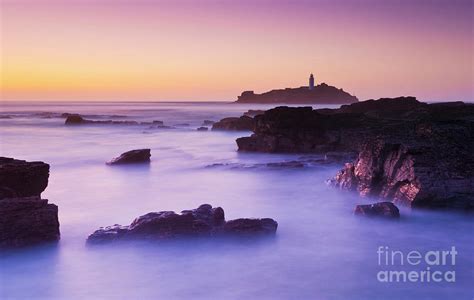 Sunset at Godrevy lighthouse, Cornwall, England Photograph by Neale And ...