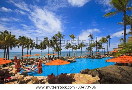 The Swimming Pool At The Sheraton Waikiki Hotel Sits At Waters Edge By ...