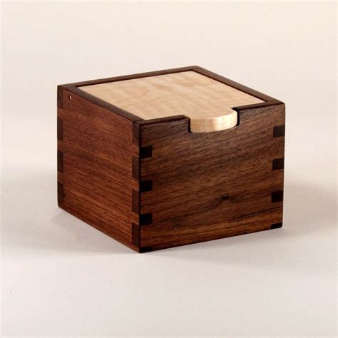 a small wooden box with a lid on it