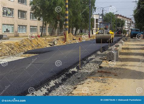 An Asphalt Paver and a Roller are in Operation Stock Photo - Image of ...