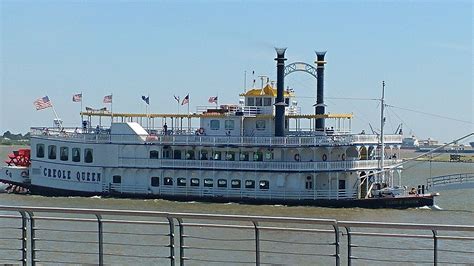 a large white boat floating on top of a river