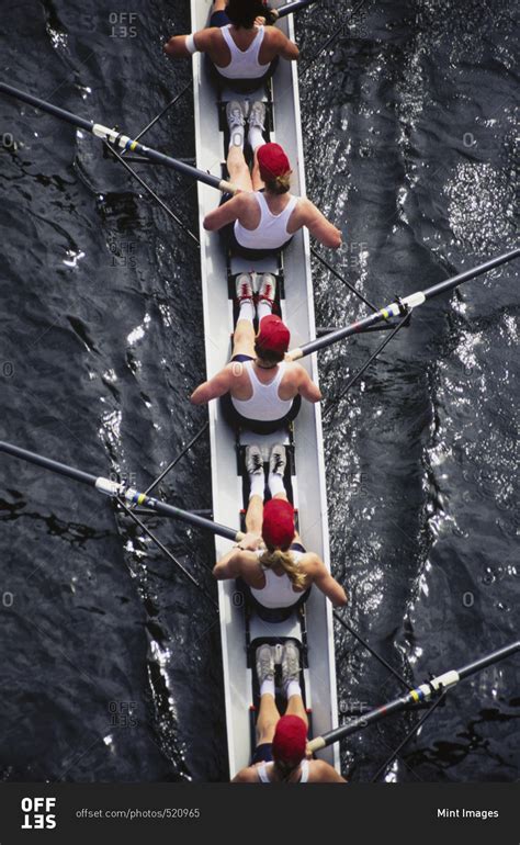 Overhead view of female crew racers rowing a sports racing shell. boat ...