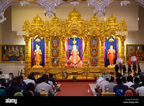 Worshippers in front of deities at the Kingsbury Hindu temple ...