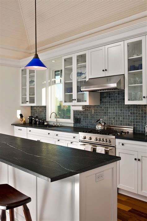 kitchen backsplash dark granite countertops, white cabinets, gray floor ...