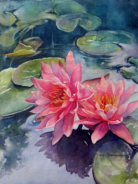 two pink water lilies floating on top of lily pads