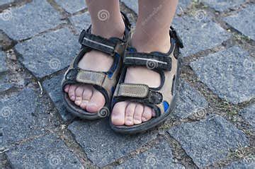 Child`s Feet in Sandals. Summer Shoes. on the Street Stock Photo ...